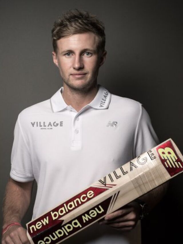 joe root in england jersey raising his bat after scoring a century
